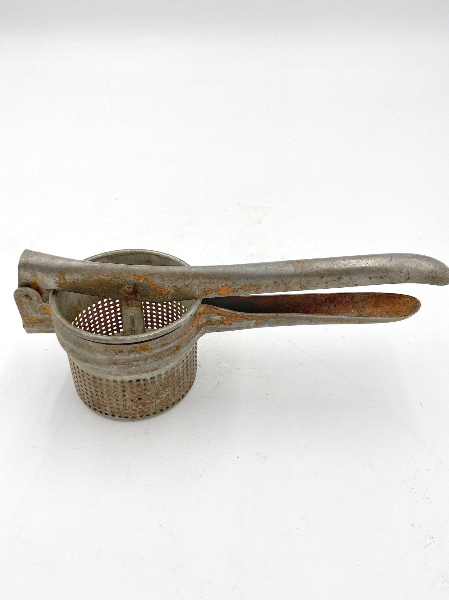 Vintage Rice Strainer, Metal Potato Masher or Fruit Juicer -Located at Funkyhouse Vintage Antique Store, Weiser Idaho